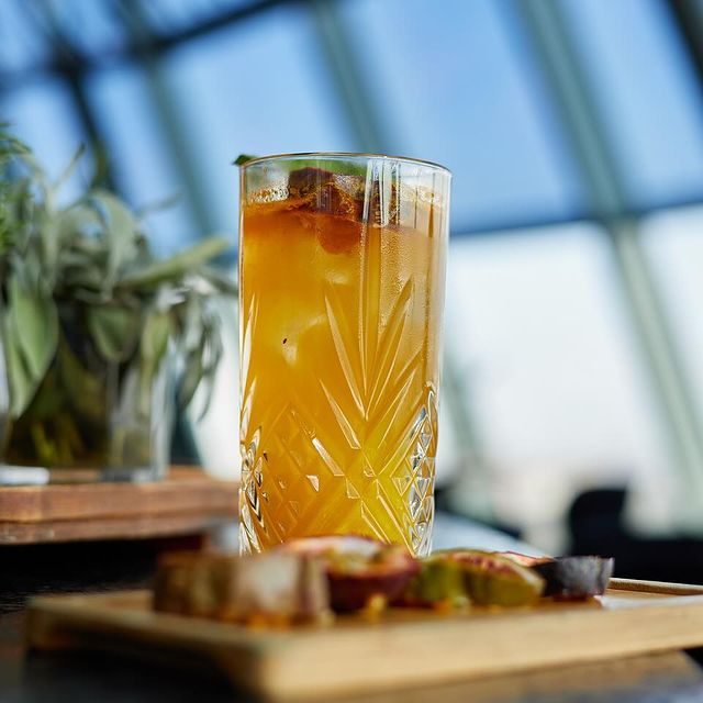 Tall amber cocktail at INTI