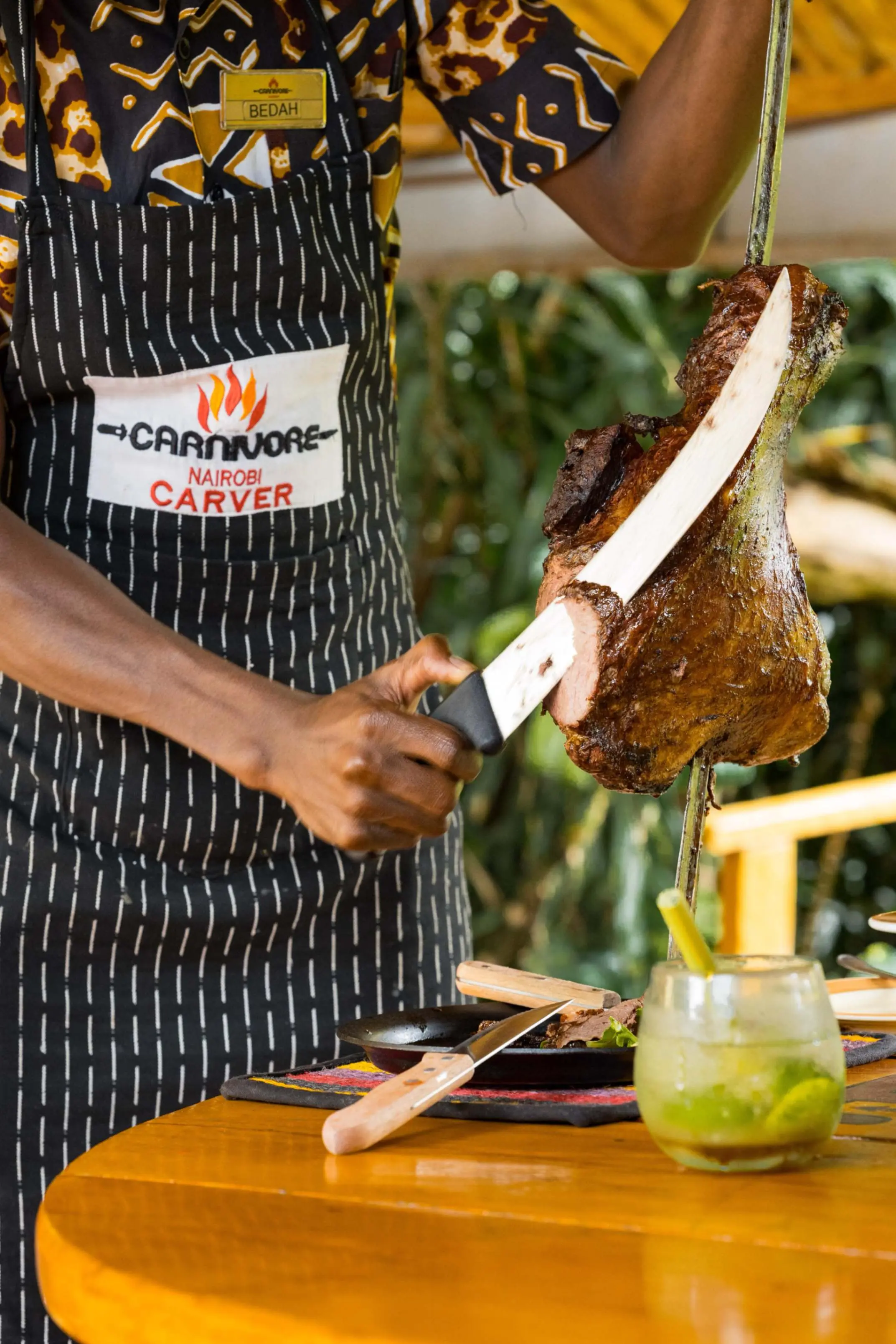 Carnivore carver presenting roasted meat